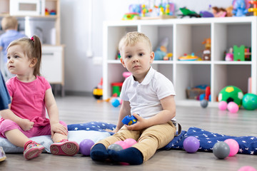 Group of babies playing in kindergarten