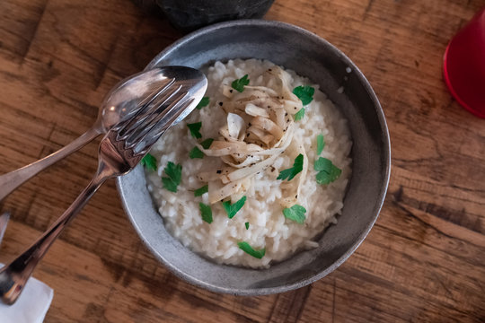 Creamy rice with old cheese, celeriac and truffle seen from above