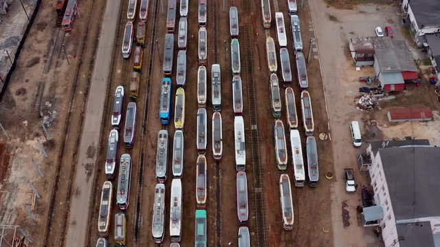 Aerial view of tram depo with many old trams.