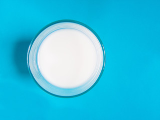A glass of milk with a blue background