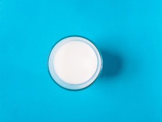 A glass of milk with a blue background