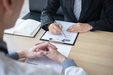 Employer or recruiter holding reading a resume during about colloquy his profile of candidate, employer in suit is conducting a job interview, manager resource employment and recruitment concept