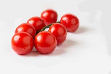 Fresh red tomatoes on a white background.