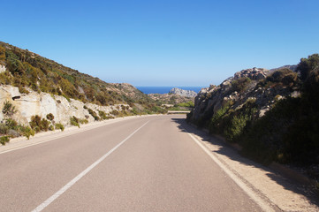 Empty clean smooth highway road close up on a sunny summer tropical island near the mountains and the sea for background.