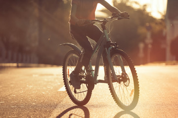 Girl Kid Riding Bike in Summer in City at Beautiful Sunset  