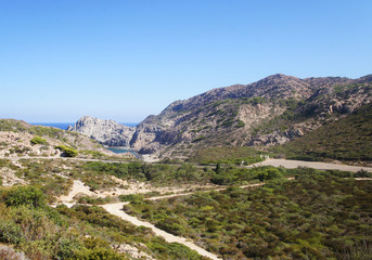 Fototapeta premium Old highway road on a sunny summer tropical island near mountains and green hills for background.