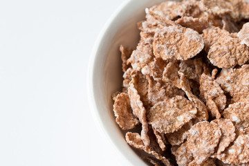 Bowl of multigrain natural flakes  on a white background. Healthy food. 