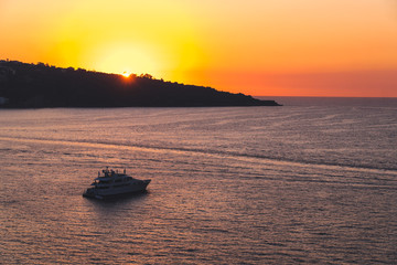 Luxury cruise ocean liner ship sailing from port on sunrise, sunset, Italy Sorrento bay, travel tour, work on the ship, vacancies, service, rest and holiday on the ship, space for text, Italy © Sergey