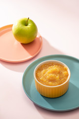 Natural baby food concept. Bowl of apple baby puree.