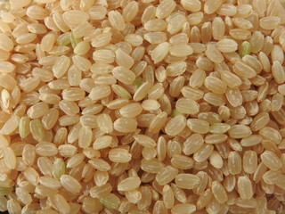 Top view of brown rice (also called hulled rice, unpolished rice,husked rice).   Nutrition rich in protein, lipids, fiber, vitamin B1. Asian, Chinese food background. Health, agriculture concept.