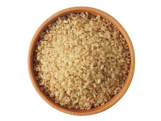 Top view of raw brown rice (also called hulled rice, unpolished rice,husked rice) on wooden bowl isolated on white background. Rich nutrition. Asian food,Health, agriculture concept. With copy space.