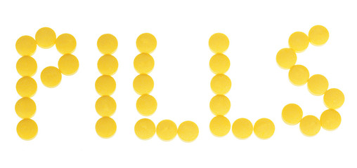 yellow vitamin pills isolated on white background