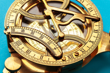 Compass on blue background, top view