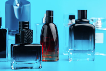 Man perfume bottle on blue background close up