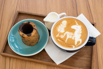 Hot latte with cookies on a wooden table