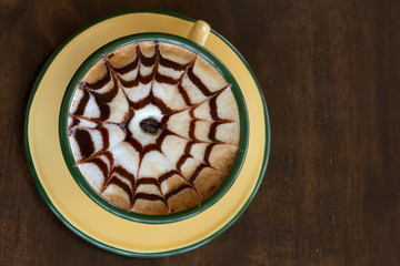 Cup of coffee is beautifully decorated, Coffee cup and coffee beans on a wooden table.
