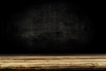 Dark desk background of free space for your decoration and black wall space 