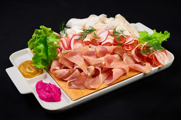 meat and sowbelly set. pub, restaurant, bar food concept. meat appetizers set with meat, sowbelly, tomatoes cherry, souses and fresh greens.