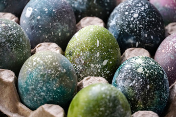Boiled Easter eggs painted in the style of cosmos and a distant galaxy. Easter.