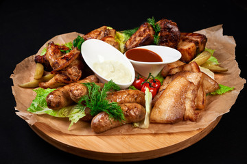 meat and snack set. pub, restaurant, bar food concept. meat appetizers set with grill chicken, sausages, tomatoes cherry, souses and fresh greens.