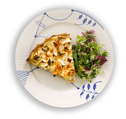 A slice of quiche with leek and feta or goats cheese on a plate with crispy leaf green salad with white background. Vegetarian food image top view.