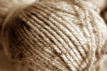 Yarn ball close-up with blur effect in brown tone.