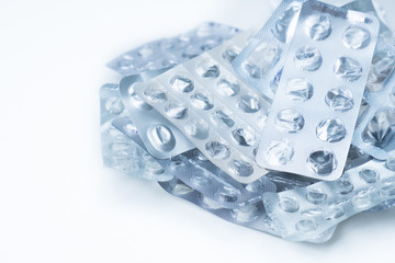 empty plastic blister packs of pills are piled in a pile. concept: pollution of nature with plastic and waste from the pharmaceutical industry