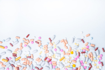 colored pills on white background whith copy space for text. Opioid epidemic, painkillers and drug abuse concept