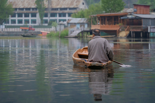 Kashmiri who lives in the lake with old wooden boat paddle in Dal Lake is the famous place of travel destination in Srinagar India