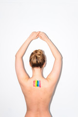 Obraz premium LGBT flag painted on girl’s bare back