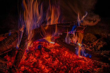 Close up shot of burning firewood in the fireplace, summer bonfire at night 