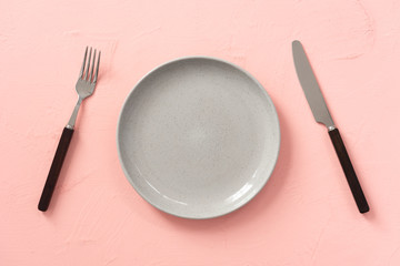 space pink vintage plate with fork and knife background