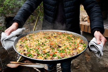 man with a typical spanish paella