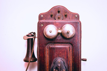 Retro phone on a white wall, antique isolated on white background.