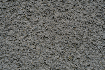 Decorated house wall with stones  texture background material. Design and decoration with small stones. For concrete and architecture wallpapers and background.