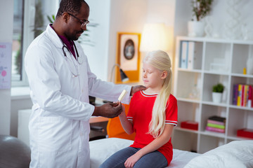 Pediatrician giving ice cream for daughter visiting him at work