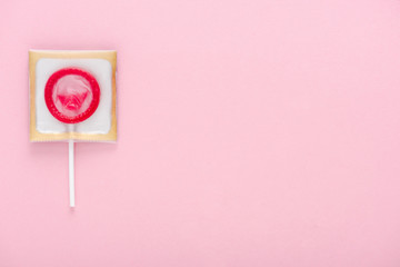 top view of condom wrapped as lollipop isolated on pink with copy space, Safe Sex concept