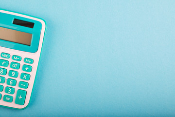 close-up and selective focus shot, calculator on blue background. copy space for text