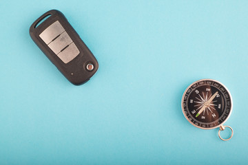 travel and vacation concept, flat lay car key and compass on blue background.copy space for text - 265632404