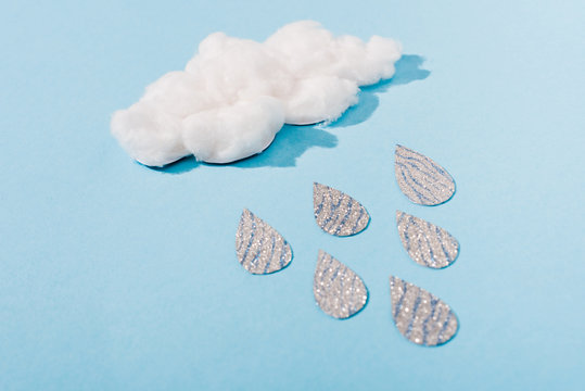 cotton candy cloud with glitter raindrops on blue