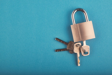 locked Padlock and bunch of key on the blue background.copy space for text - 265633230