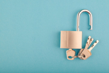 unlocked Padlock and bunch of key on the blue background.copy space for text © amirul syaidi