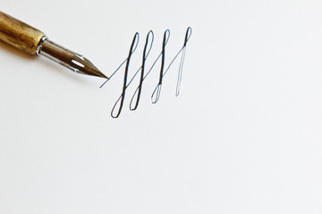 patterns drawn with an ink pen on a white paper sheet with stripes drawn. stationery close up top...