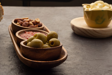 Olive, toasted peanuts and fried tomato
