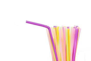 Many bright multi-colored plastic tubes for beverages on a white background.