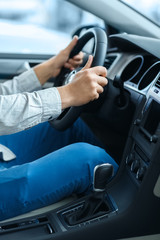 Comfort of driving. Vertical cropped shot of a man holding a steering wheel while sitting in a car