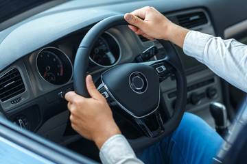 Elegance of the interior. Cropped closeup shot of the hands of a man on a steering wheel