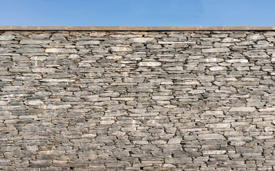 Grey stone wall around a property