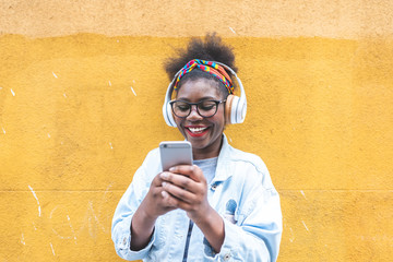 Afro American Teenage Girl Using Mobile Phone Outdoors.