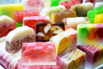Natural handmade soap bars different colors stand in a row. Fruit colorful natural organic spa soap. Handmade soap, spa, beauty skincare concept.